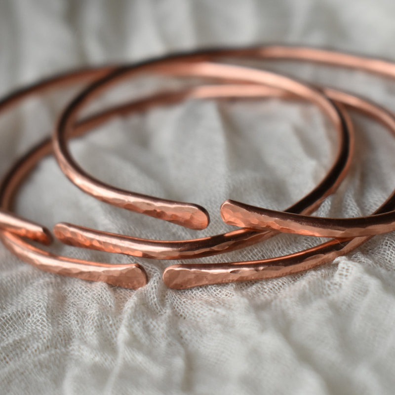 Adjustable gemstone copper rings and bracelets for men and women.