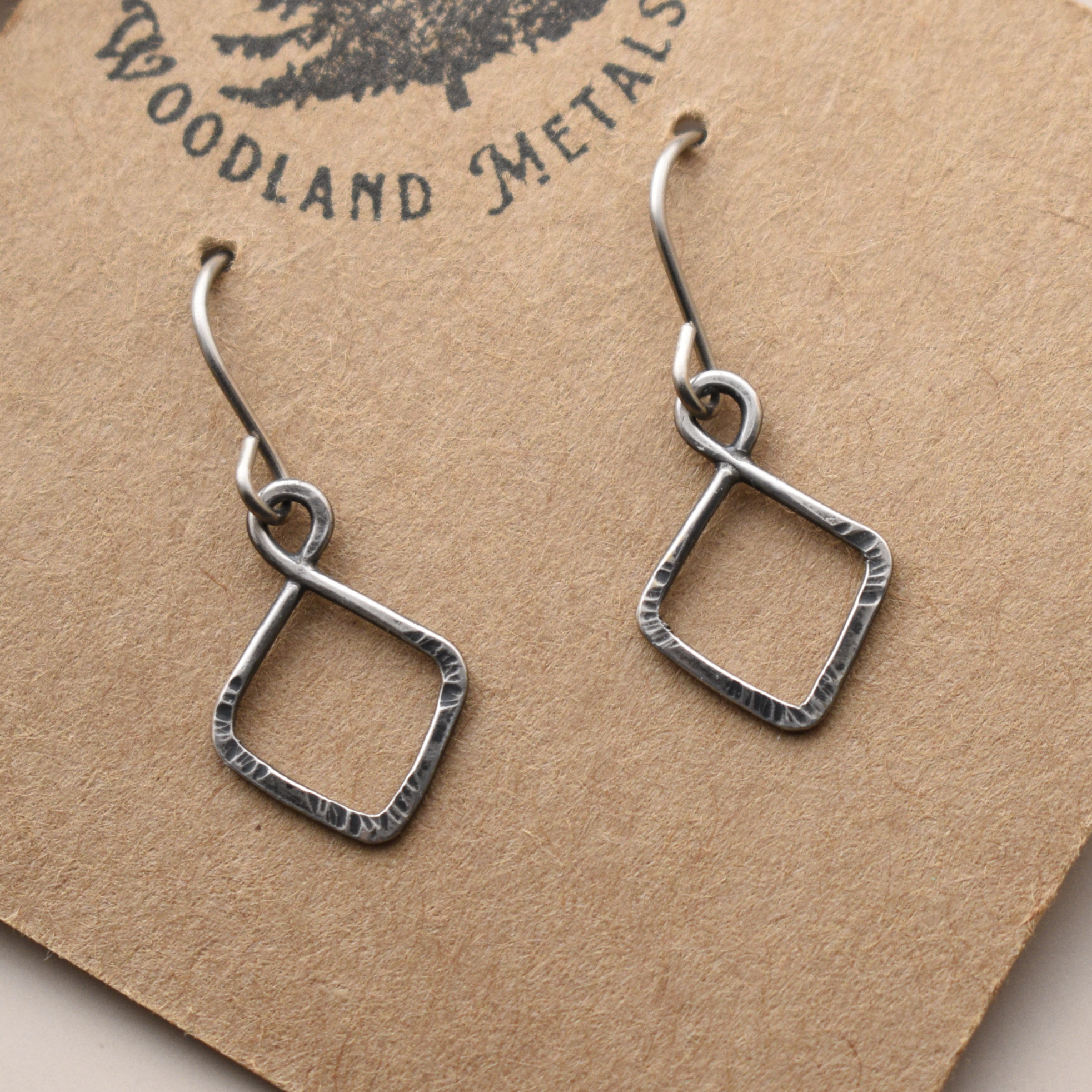 Pair of small silver square earrings