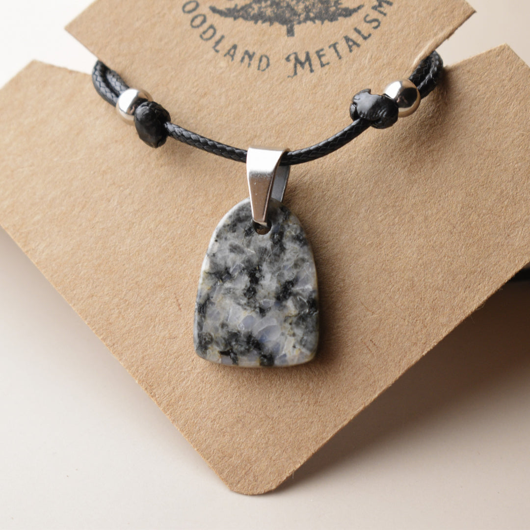 Necklace with a Diorite stone pendant on a Woodland Metals card