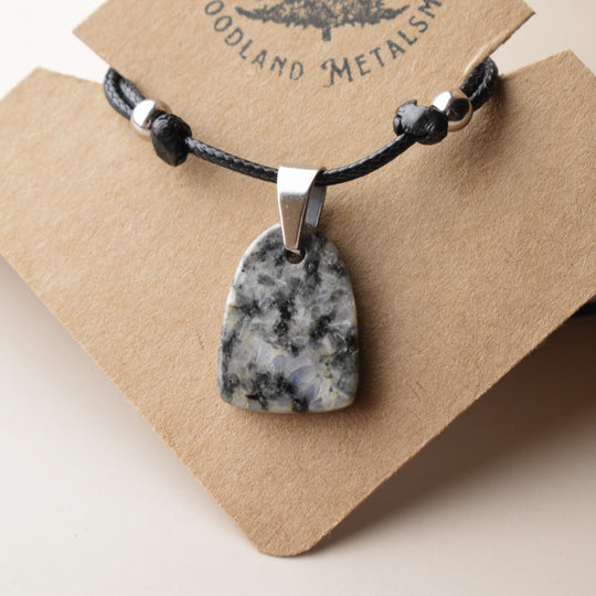 Necklace with a Diorite stone pendant on a Woodland Metals card