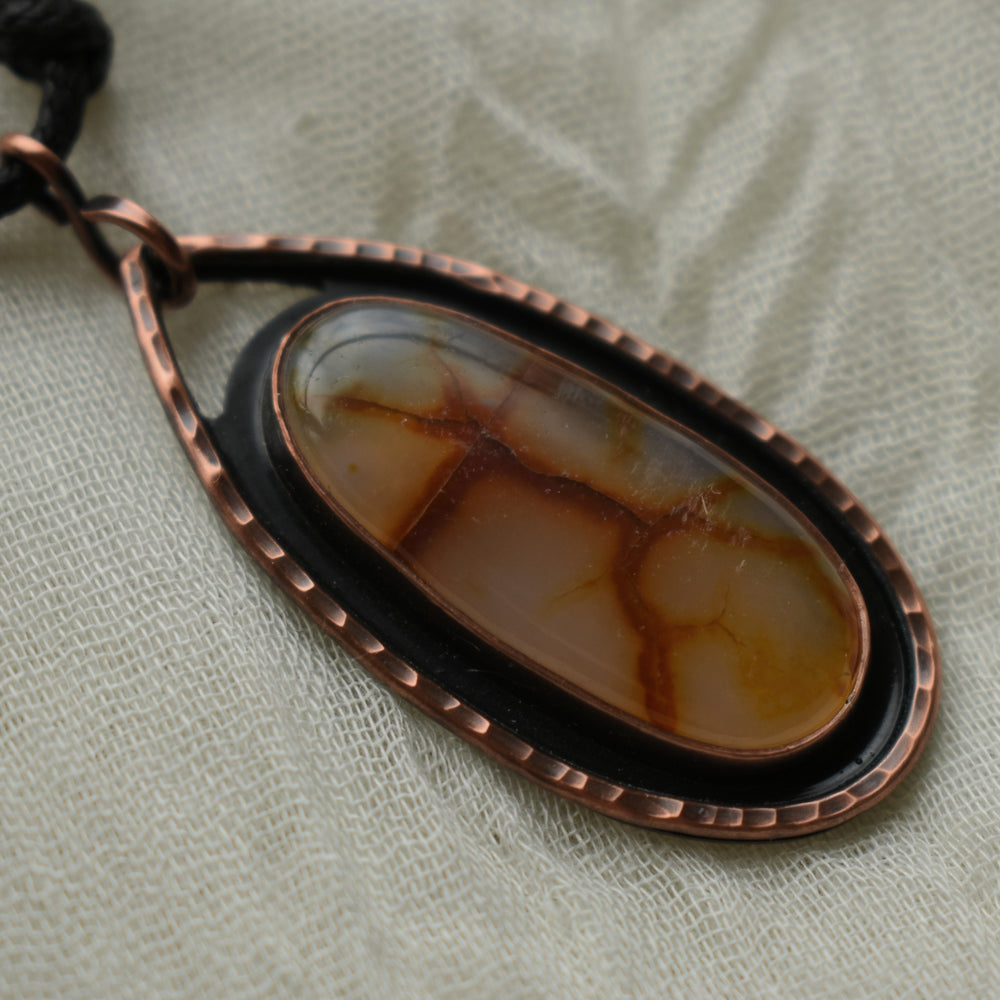 metalsmith pendant necklace made with carnelian agate and pure copper