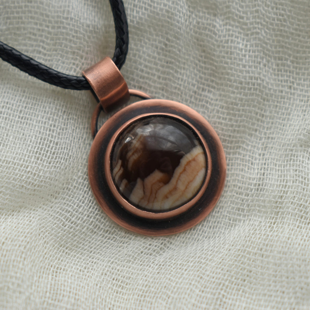 dainty pendant necklace handmade with petrified wood and pure copper