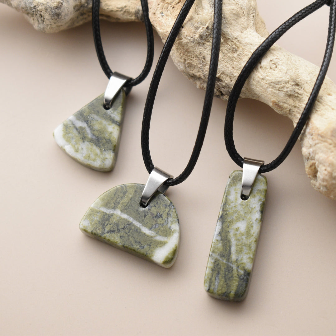 Green stone pendants on black cords