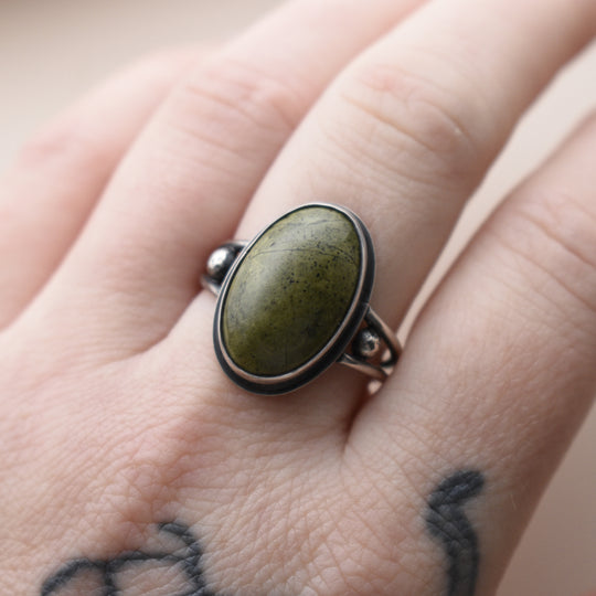 Ring with a green stone on a person's finger