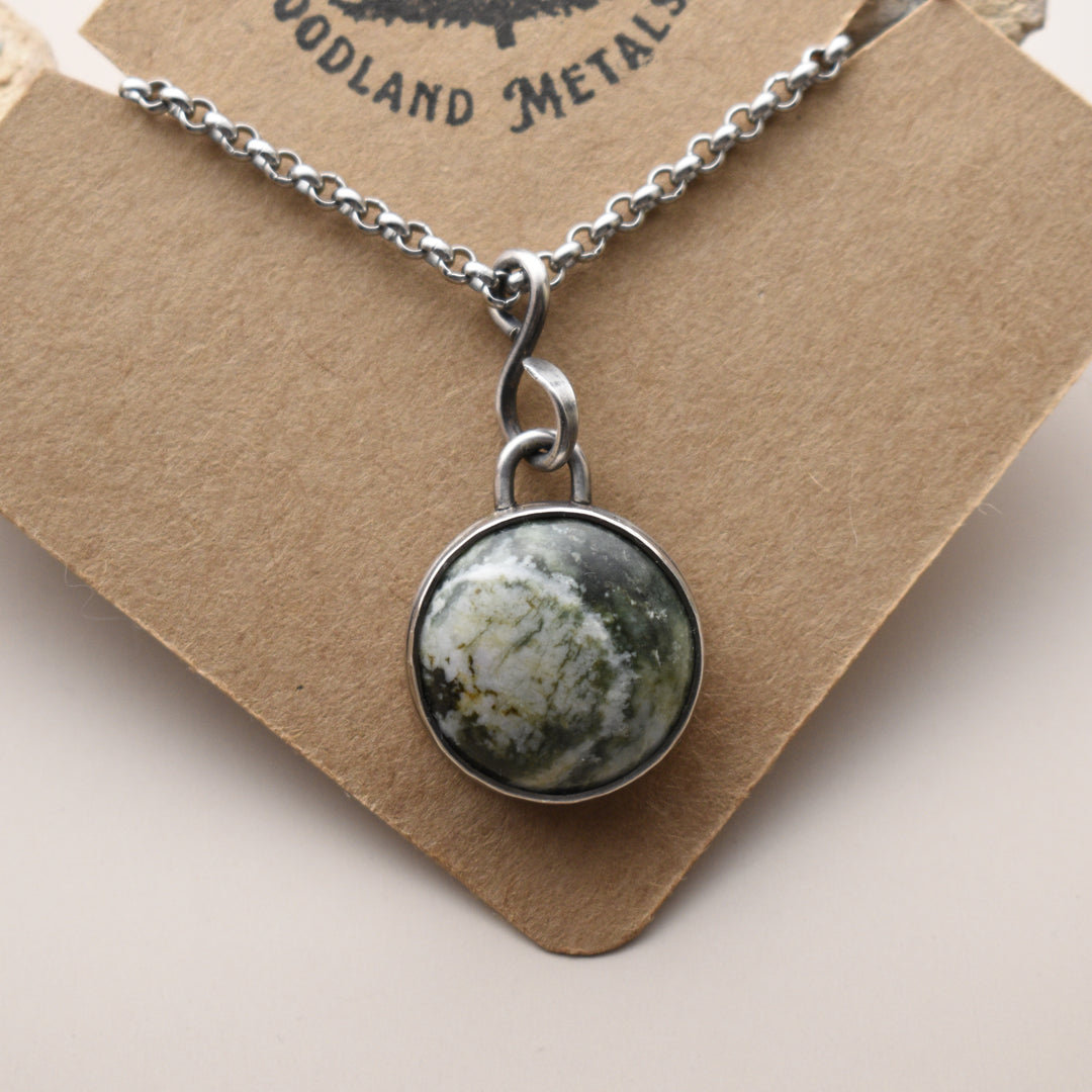 Necklace with a round Jasper pendant on a brown card with 'Woodland Metalsmith' branding.