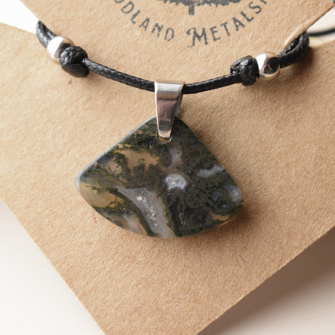 Necklace with a Moss agate stone pendant on a brown card