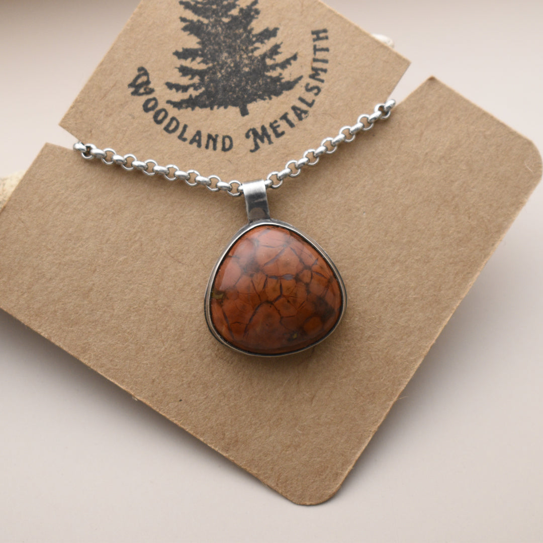 Necklace with a brown pendant on a Woodland Metalsmith card