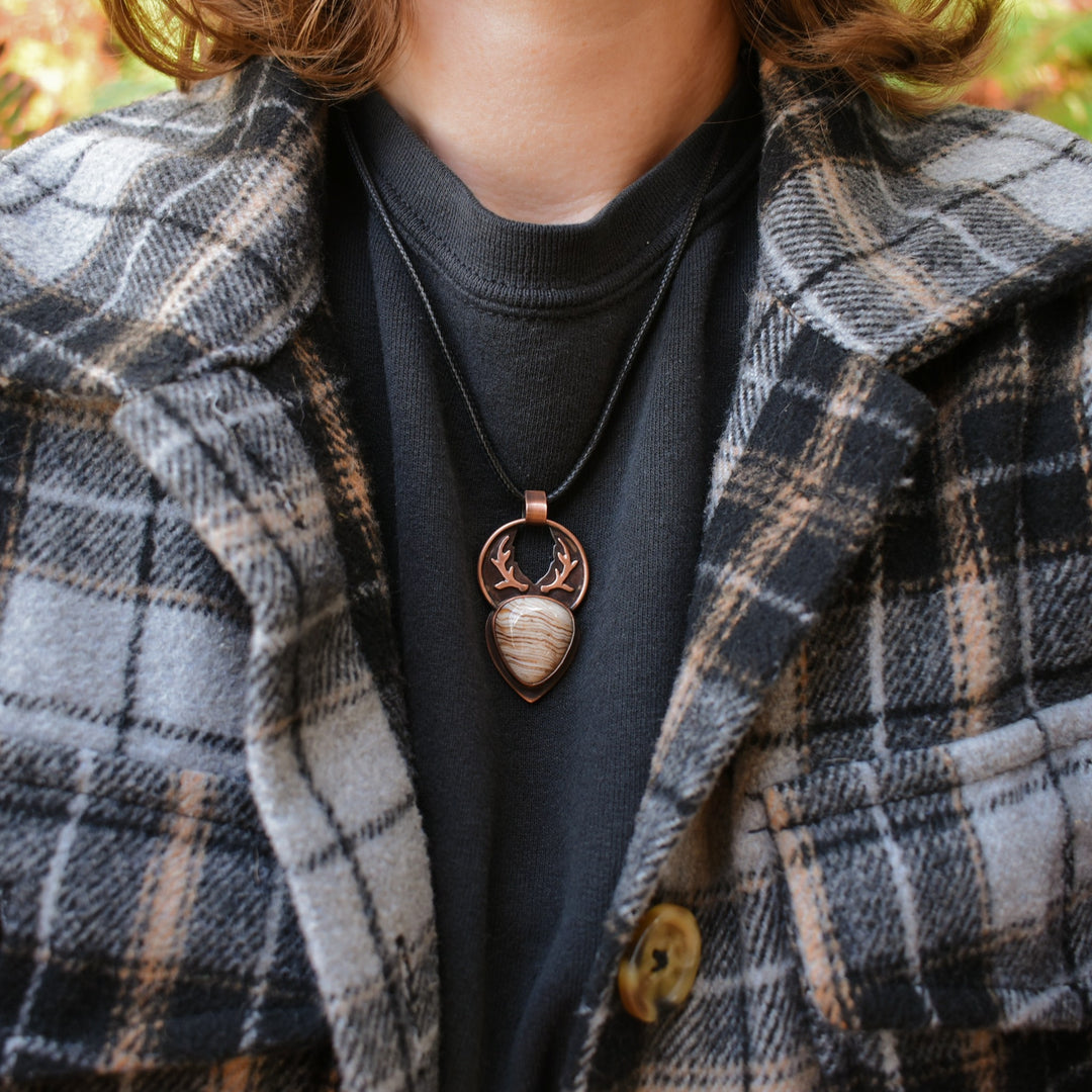 metalsmith pendant made with petrified wood and copper