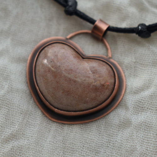 Handmade copper pendant necklace made with a pink Jasper heart