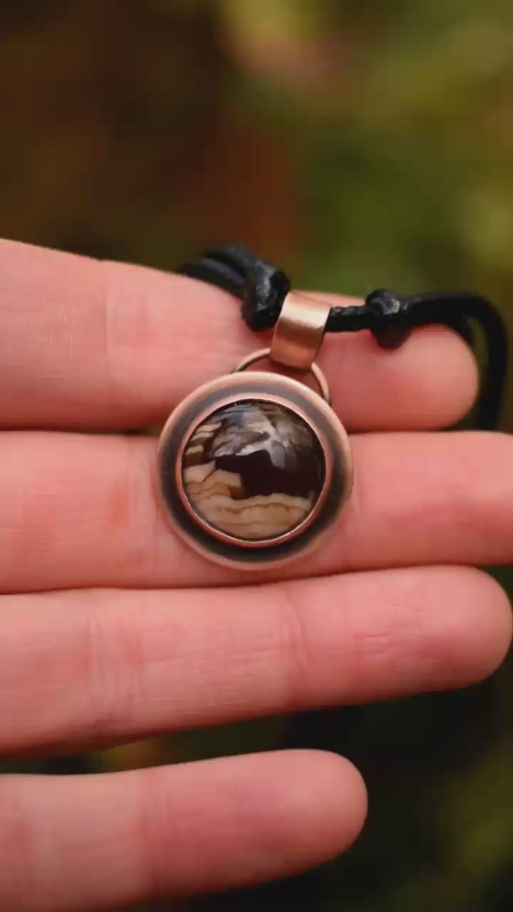 small pendant necklace made with petrified wood and copper