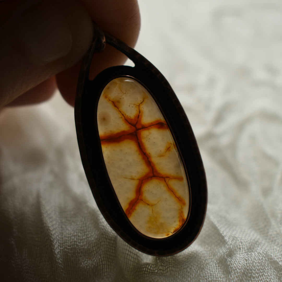 this rustic pendant is handcrafted with carnelian agate and copper