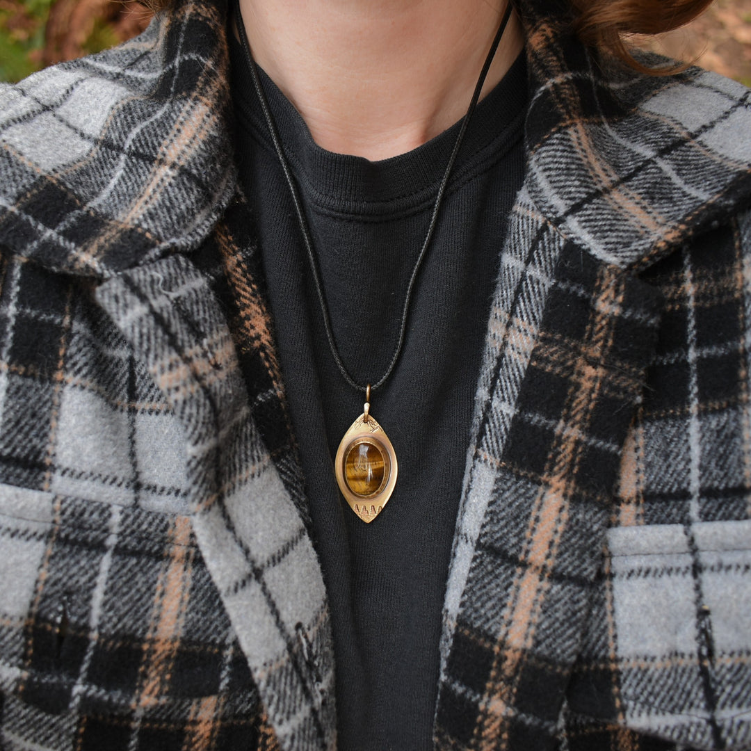 metalsmith pendant made with solid brass and tigers eye