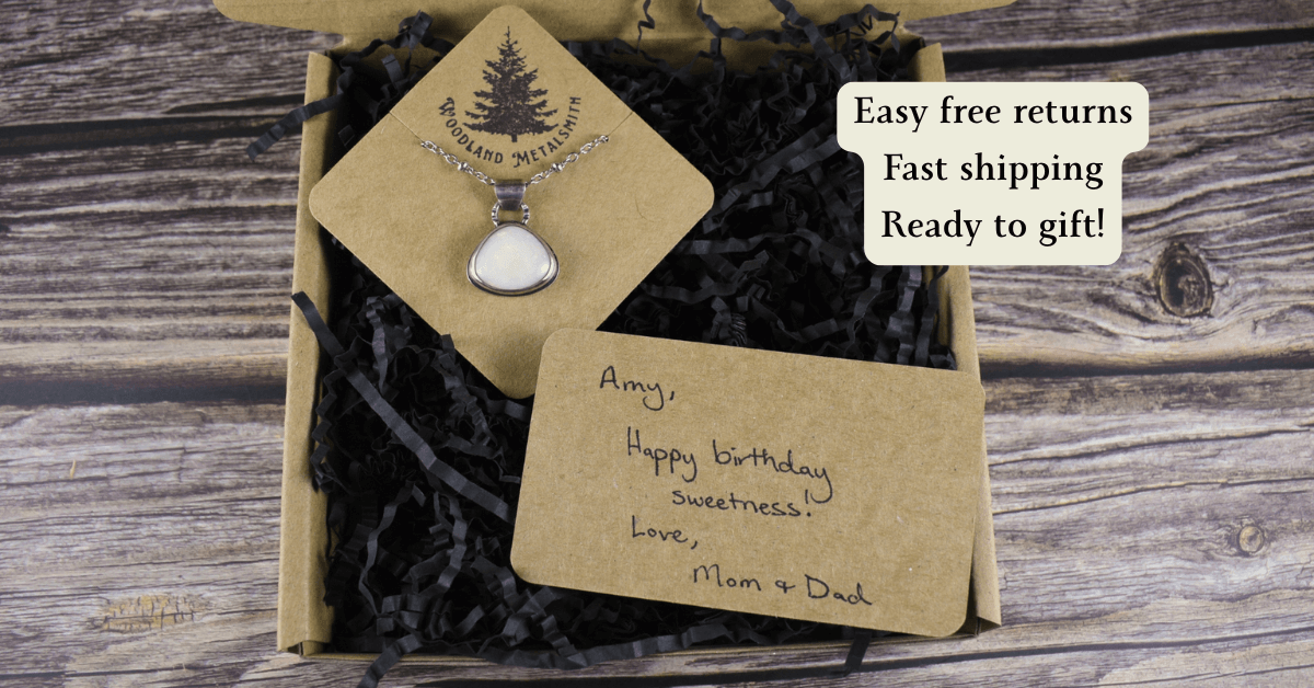 Necklace in a gift box with personalized message on a wooden surface