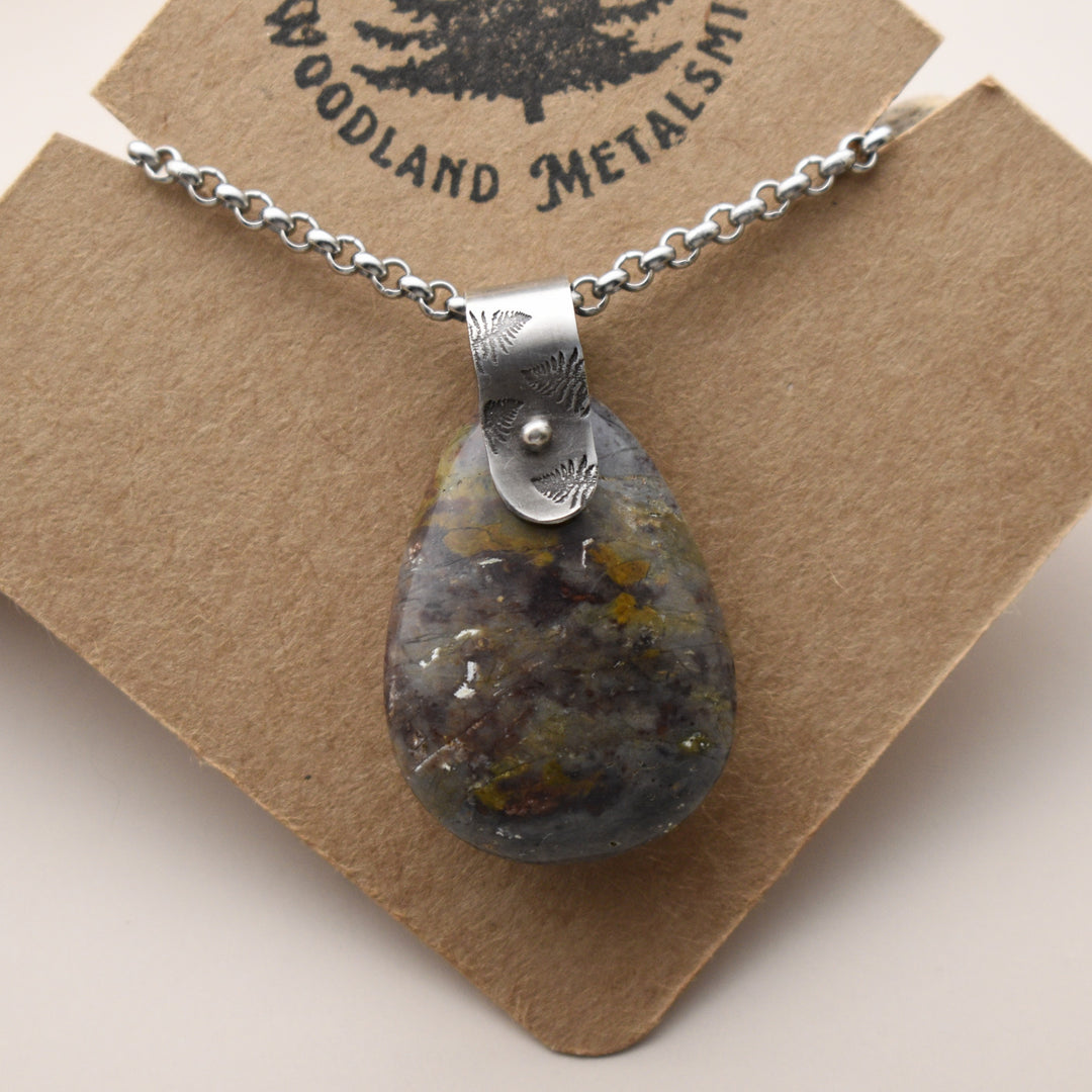 Necklace with a teardrop-shaped Jasper pendant on a brown card with 'Woodland Metalsmith' branding.