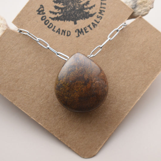 Necklace with a brown pendant on a Woodland Metalsmith card